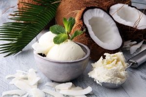 Bowl with balls of coconut ice cream and desiccated coconut